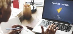 Woman at laptop with new product launch on screen